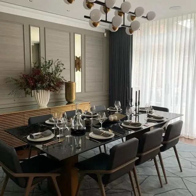 Completed Hampstead residence dining room with marble table, globe chandelier and panelled walls