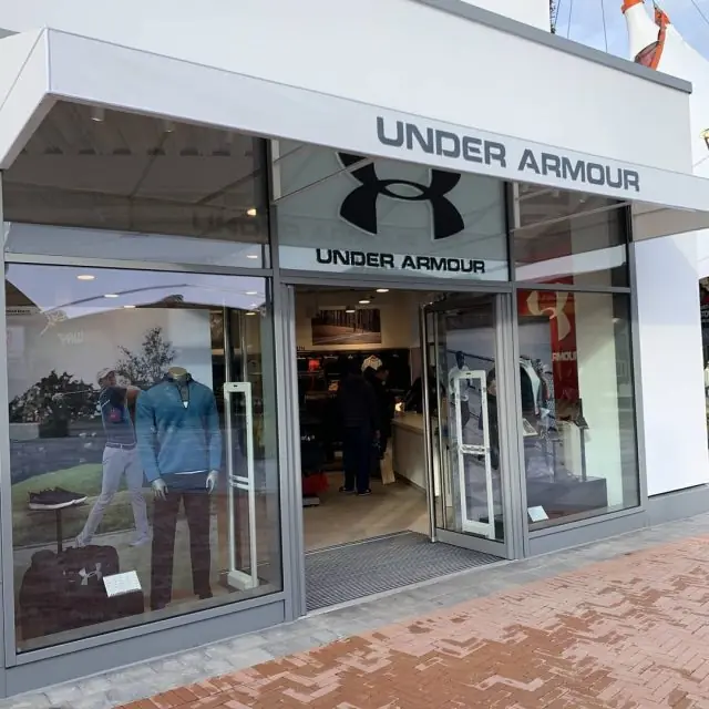Under Armour store at Ashford outlet: white canopy, glazed shopfront and open entrance, BREEAM Retail scheme