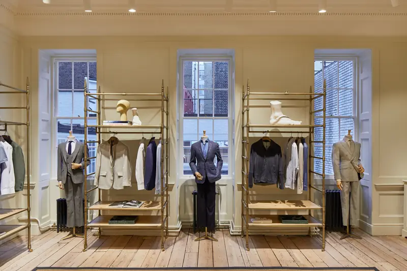 Bright Hackett Savile Row showroom with sash windows, tailored mannequins, brass rails and cast-iron column radiators