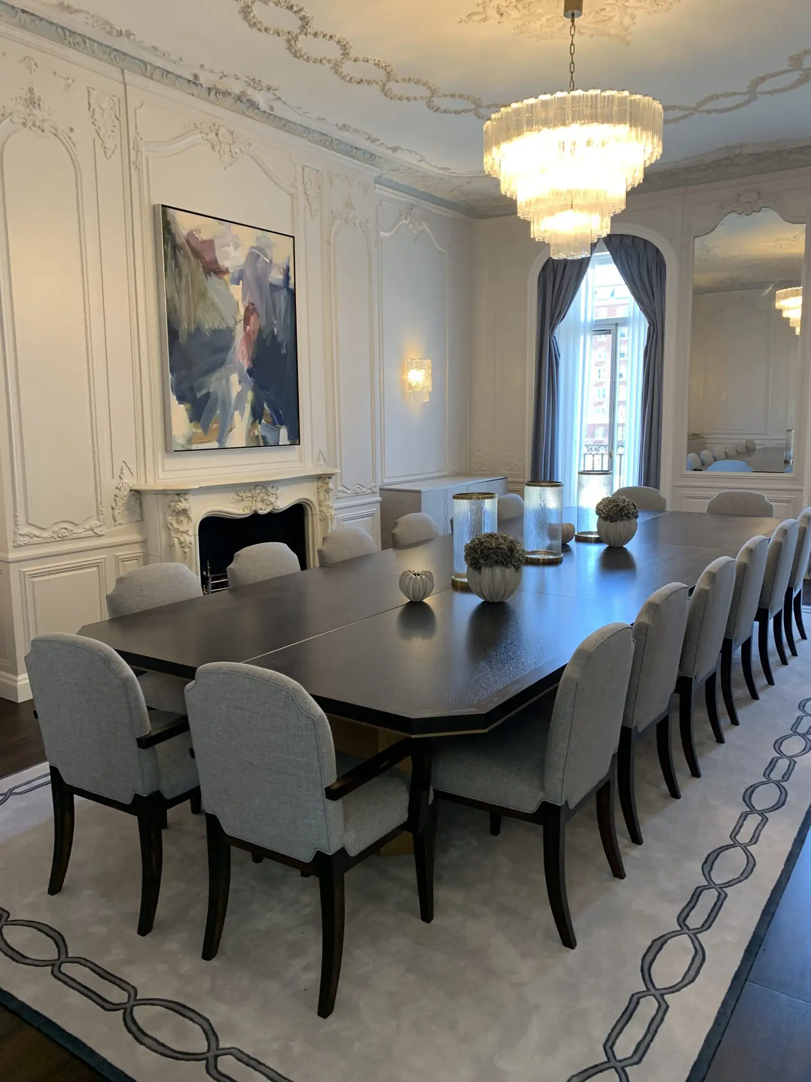 Mayfair residence dining room with Rococo plasterwork, tiered glass chandelier and a long table for sixteen